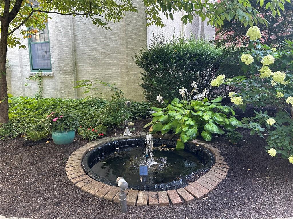 Image 4: Pretty water feature on the corner outside this un