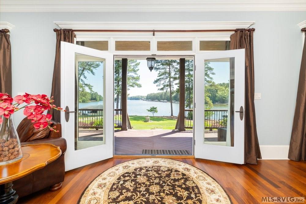 Image 3: Doorway to Lake Gaston , Seamlessly blend indoor and outdoor living with elegant French doors that open from the living room to reveal a breathtaking, unobstructed view of Lake Gaston&mdash;the perfect backdrop for morning coffee o