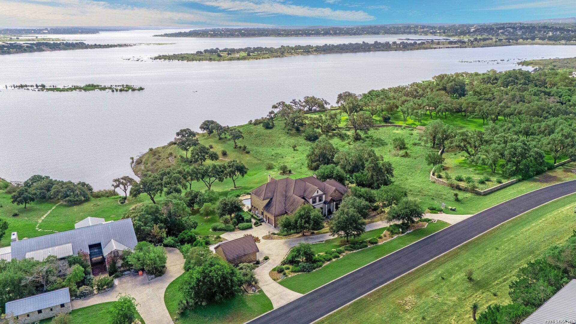 Image 1: Aerial view of estate and Canyon Lake waterfront.