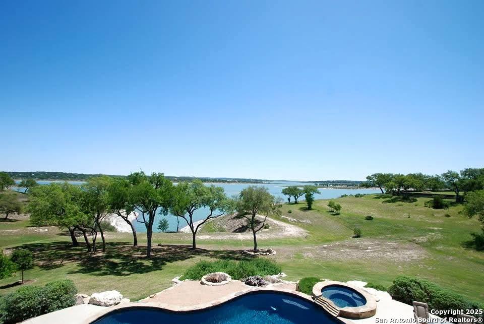 Image 3: View across pool to rear of property.