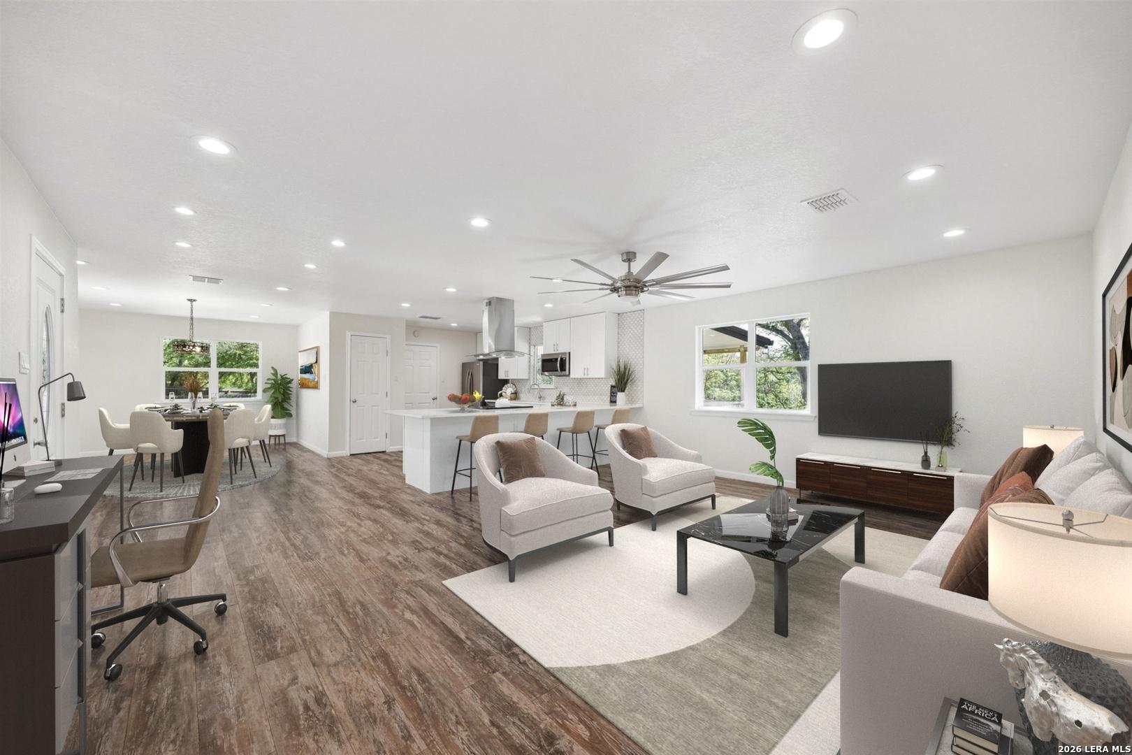 Image 1: Expansive open-concept layout connecting the kitch