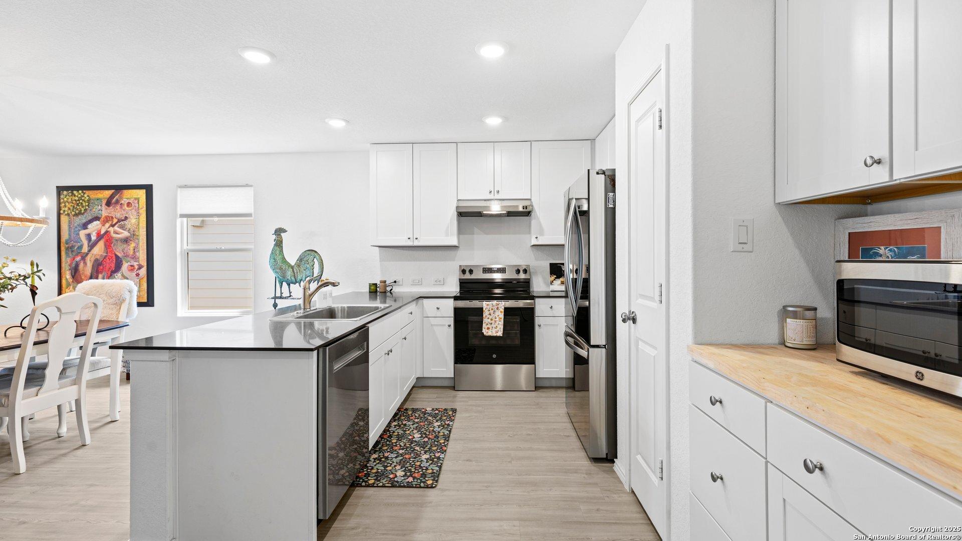 Image 4: Added cupboards and counter space in the kitchen