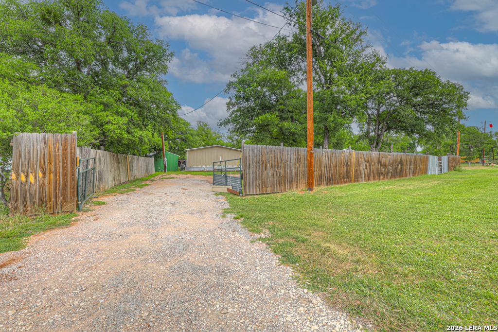 Image 2: Gated entrance to the fully fenced property