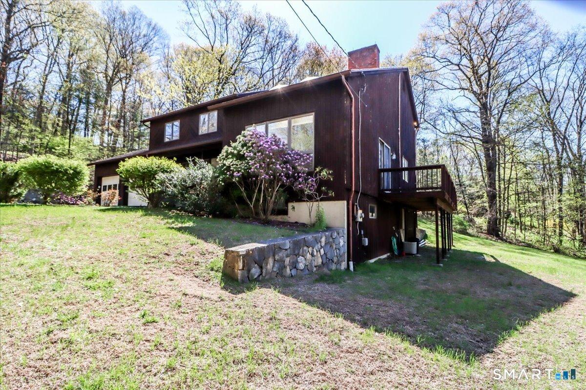 Image 2Side Yard: separate entrance to finished lower level is under deck.