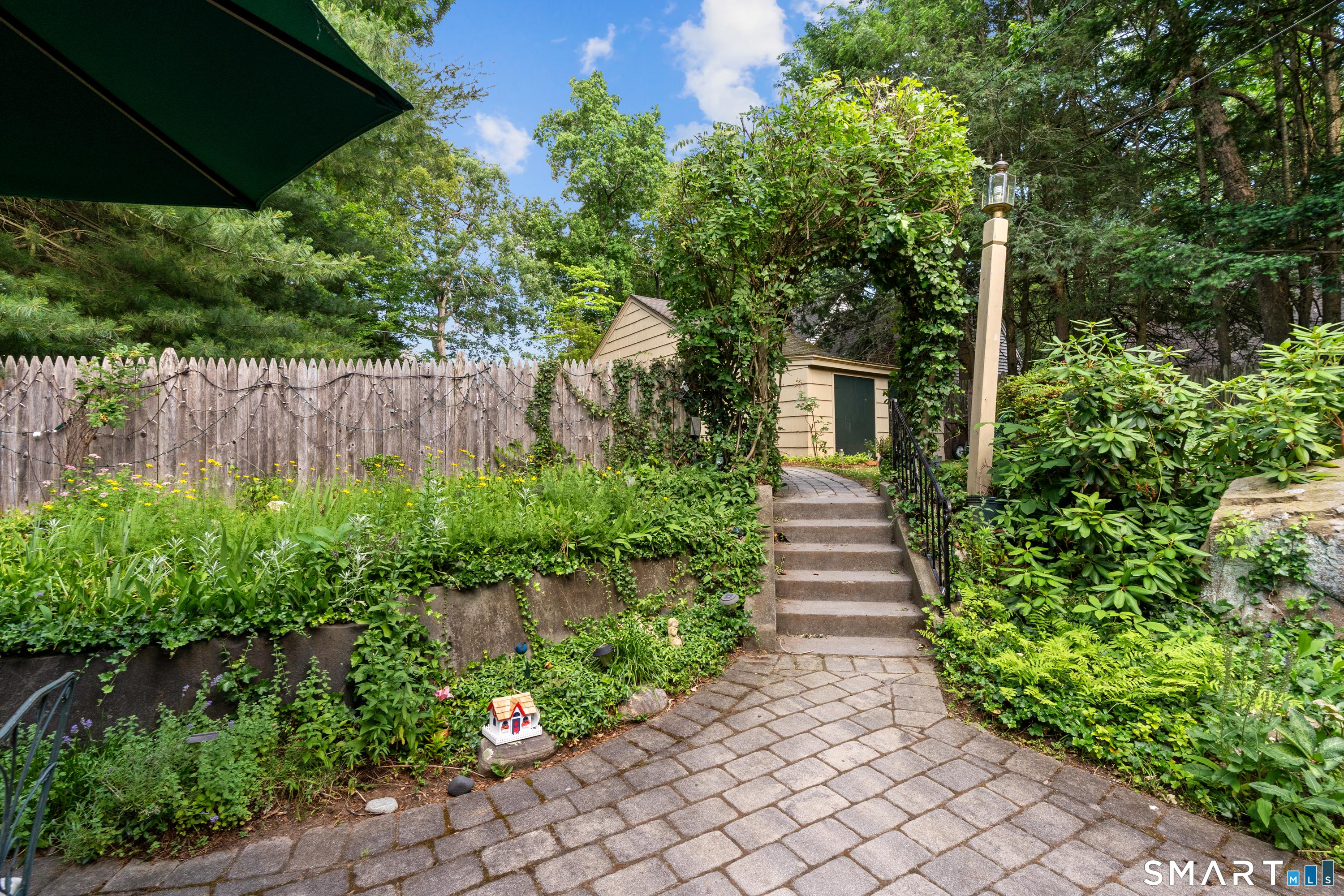 Image 4: Enjoy the mature and magical plantings and landscaping surrounding this special space.