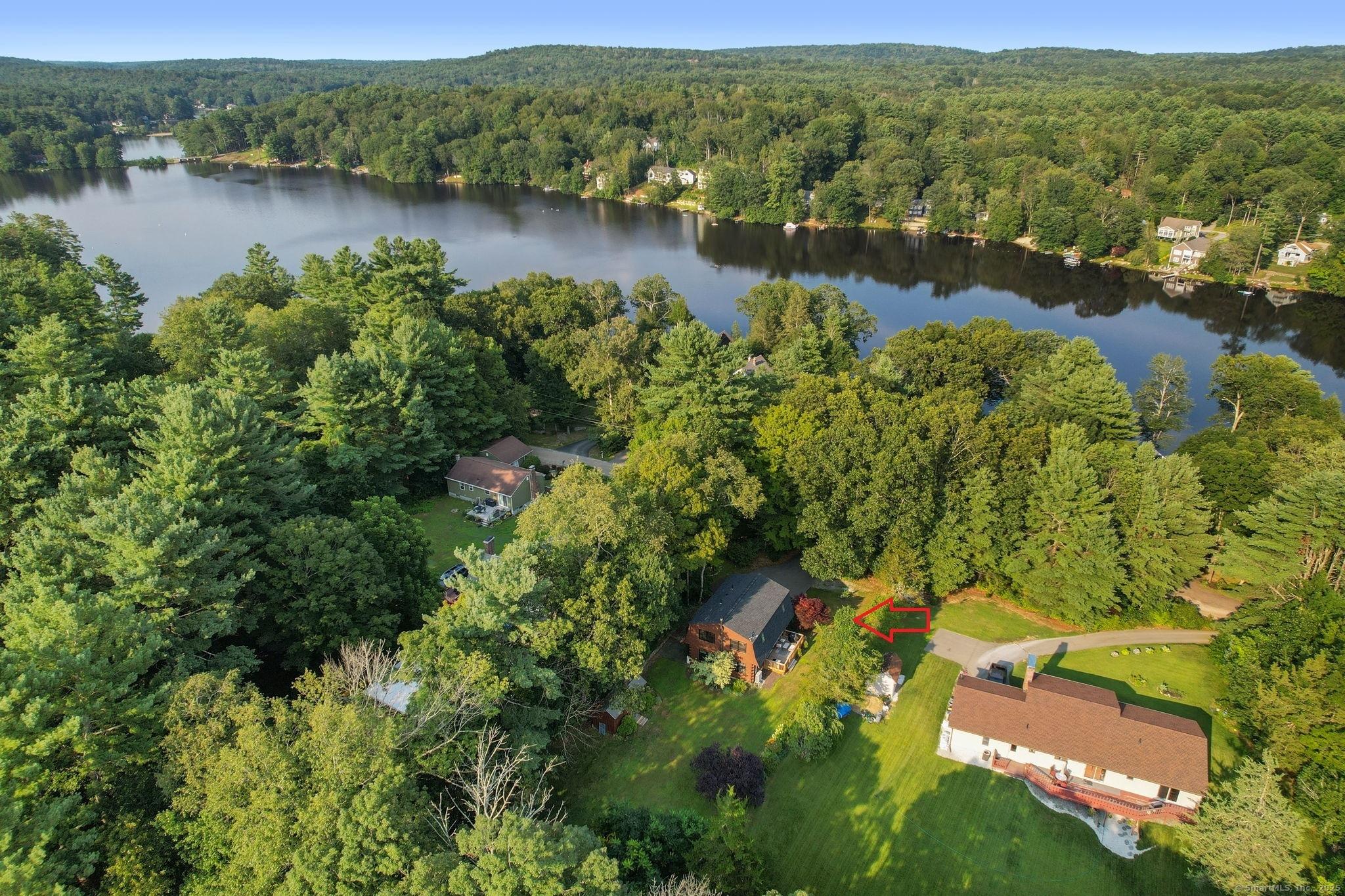 Image 2: Upgrades include new doors, a 3-year-old roof, new windows, energy-efficient mini-splits, brand new pellet stove, generator, updated electrical, new hardwoods, new kitchen, new bathrooms and fresh interior paint.