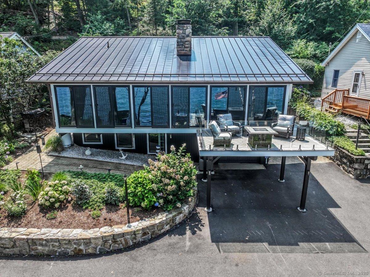 Image 3Front of House: New Metal Roof and New Rear Roof Accents the Quality of this Lake Homes upgrades