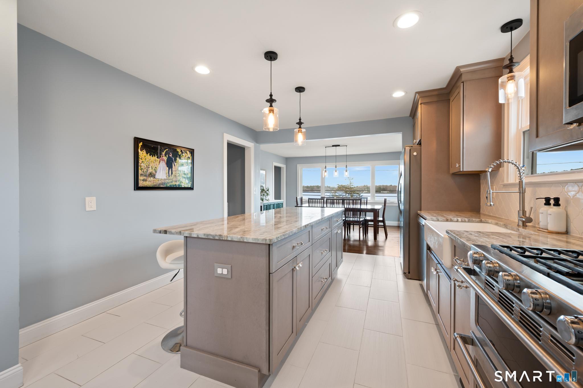 Image 3: Beautiful kitchen with granite countertops, stainless steel appliances, and tile flooring