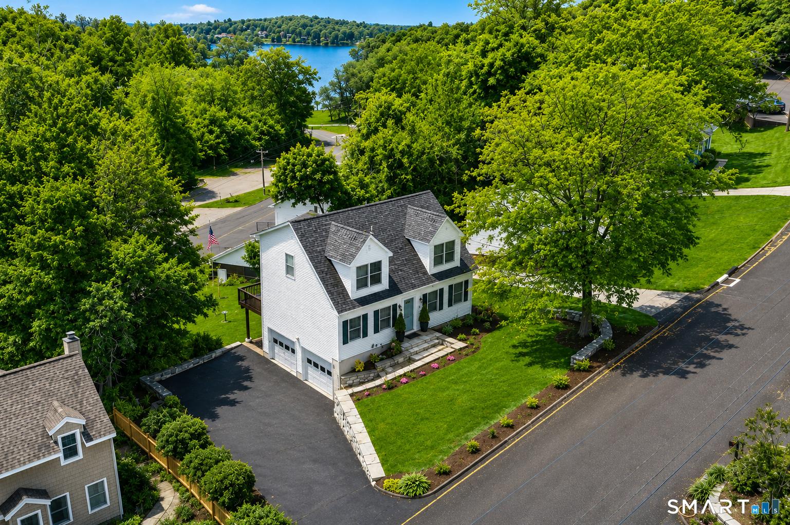 Image 1Aerial View: Elevated lakeview property offering picturesque water vistas and vibrant seasonal color. Ideally positioned to capture scenic views of the lake and surrounding shoreline.