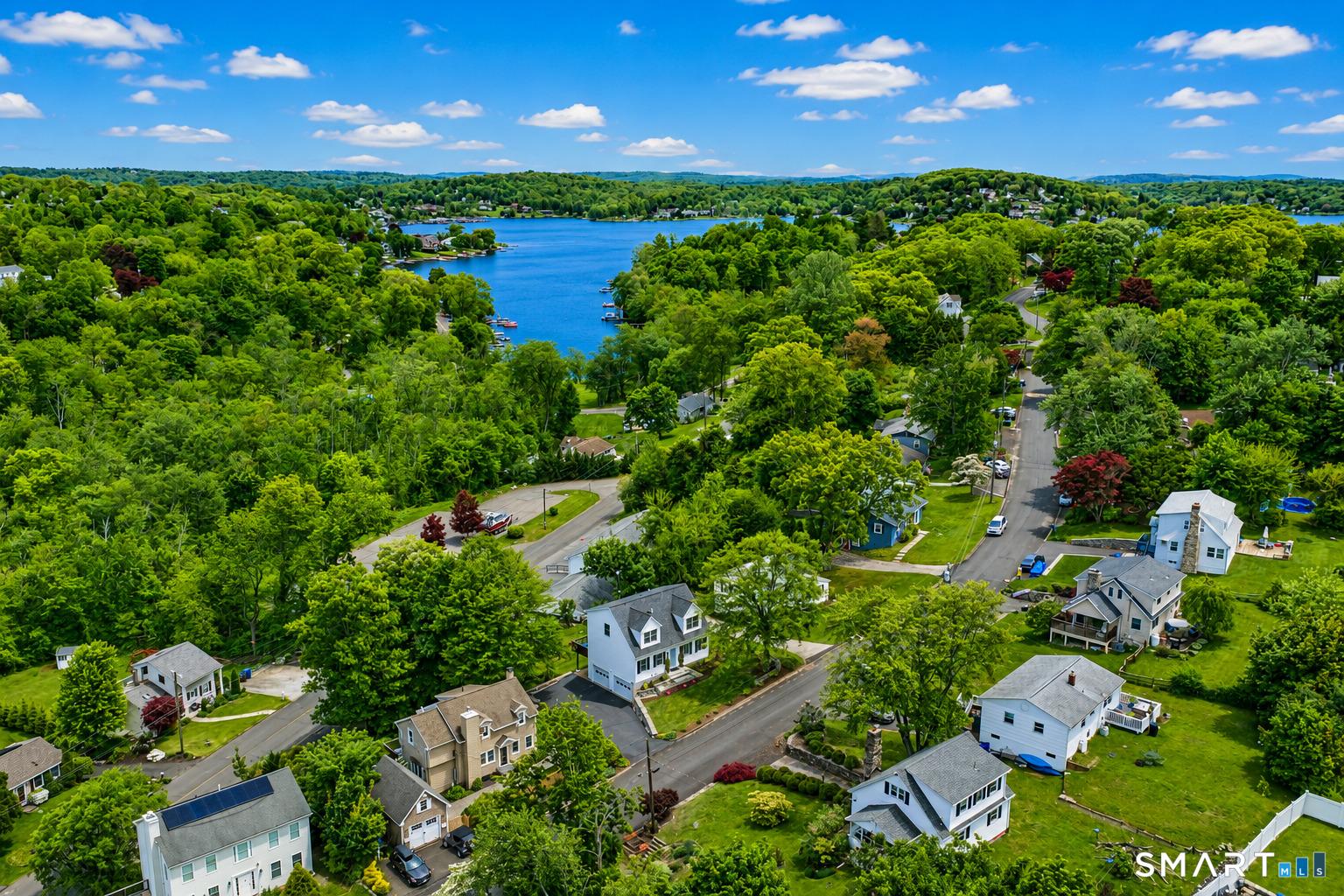 Image 2Aerial View: Aerial view of 15 Berkshire Drive in the desirable Candlewood Shores lake community, showcasing its elevated setting with lake views, and within 1,500 feet from the private community beach at Candlewood Lake.