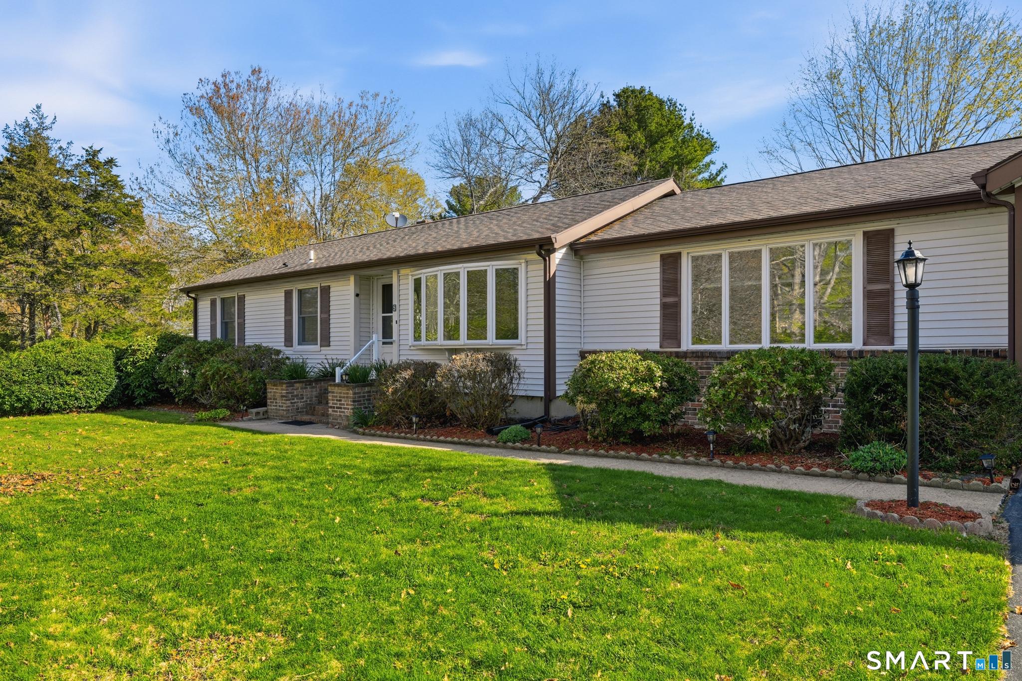 Image 2Front Yard: Expansive and open corner lot offers a sense of scale and privacy, a rare find.