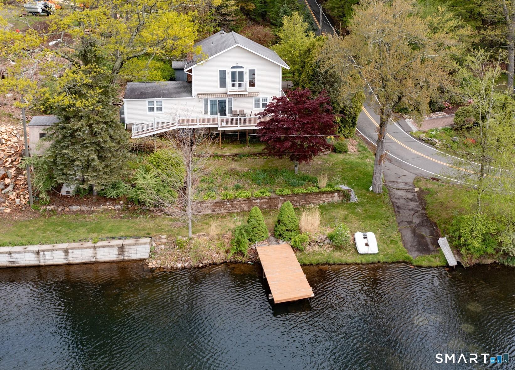 Image 1: View of the property from above the lake