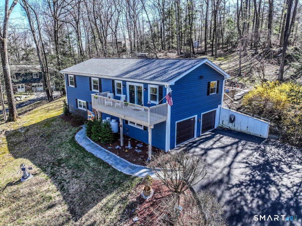 Image 1: The driveway is inclined, but beautifully repaved and provides turn around spaces or additional parking for guests in two different areas.