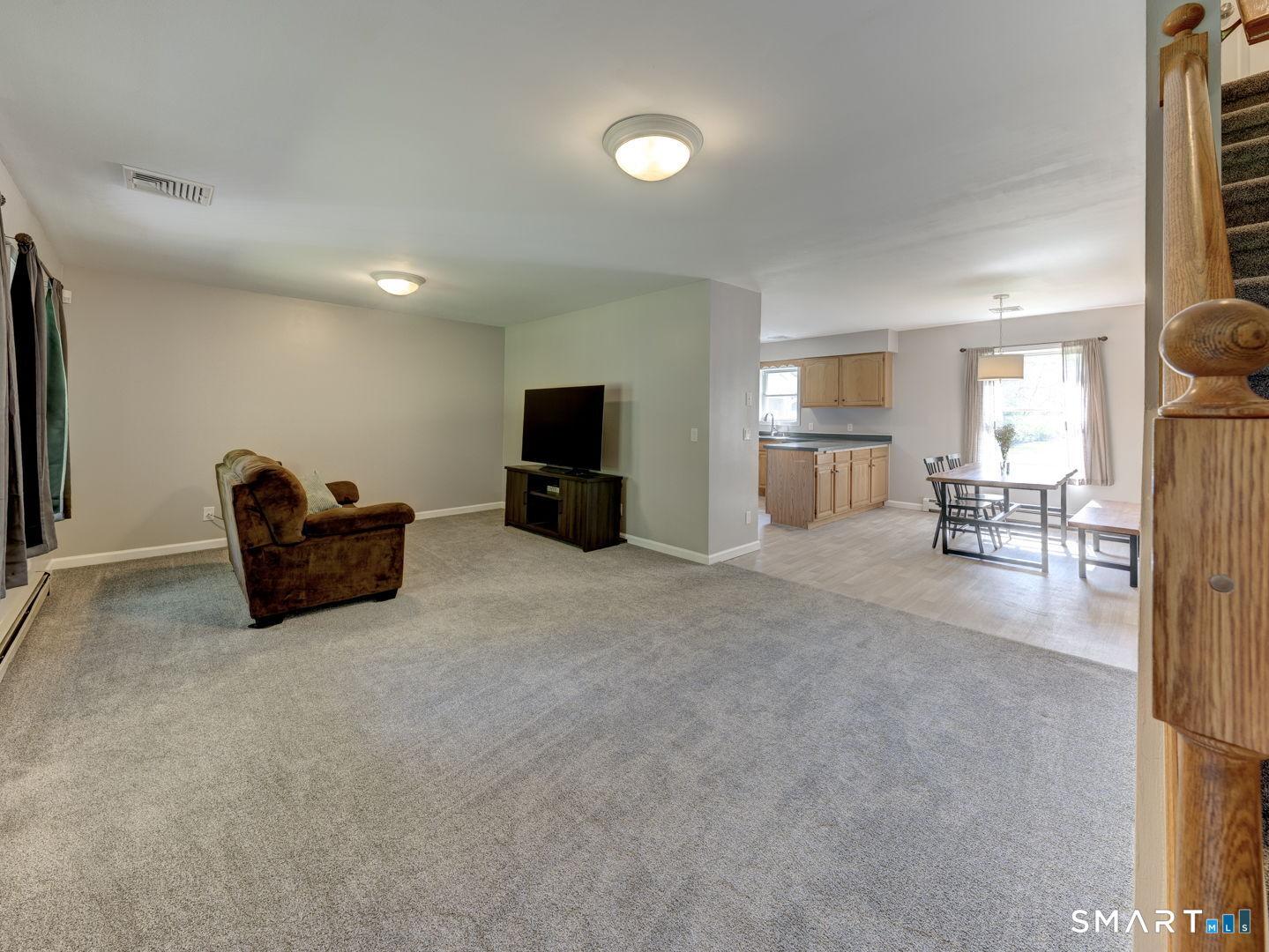 Image 3Living Room: Living room opens to dining area and kitchen.