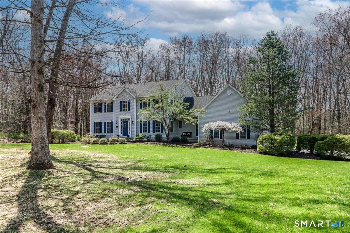 Image 2: Classic Colonial Offers Timeless Curb Appeal ~ Surrounded by Professional Landscaping, Mature Trees and a Spacious Yard