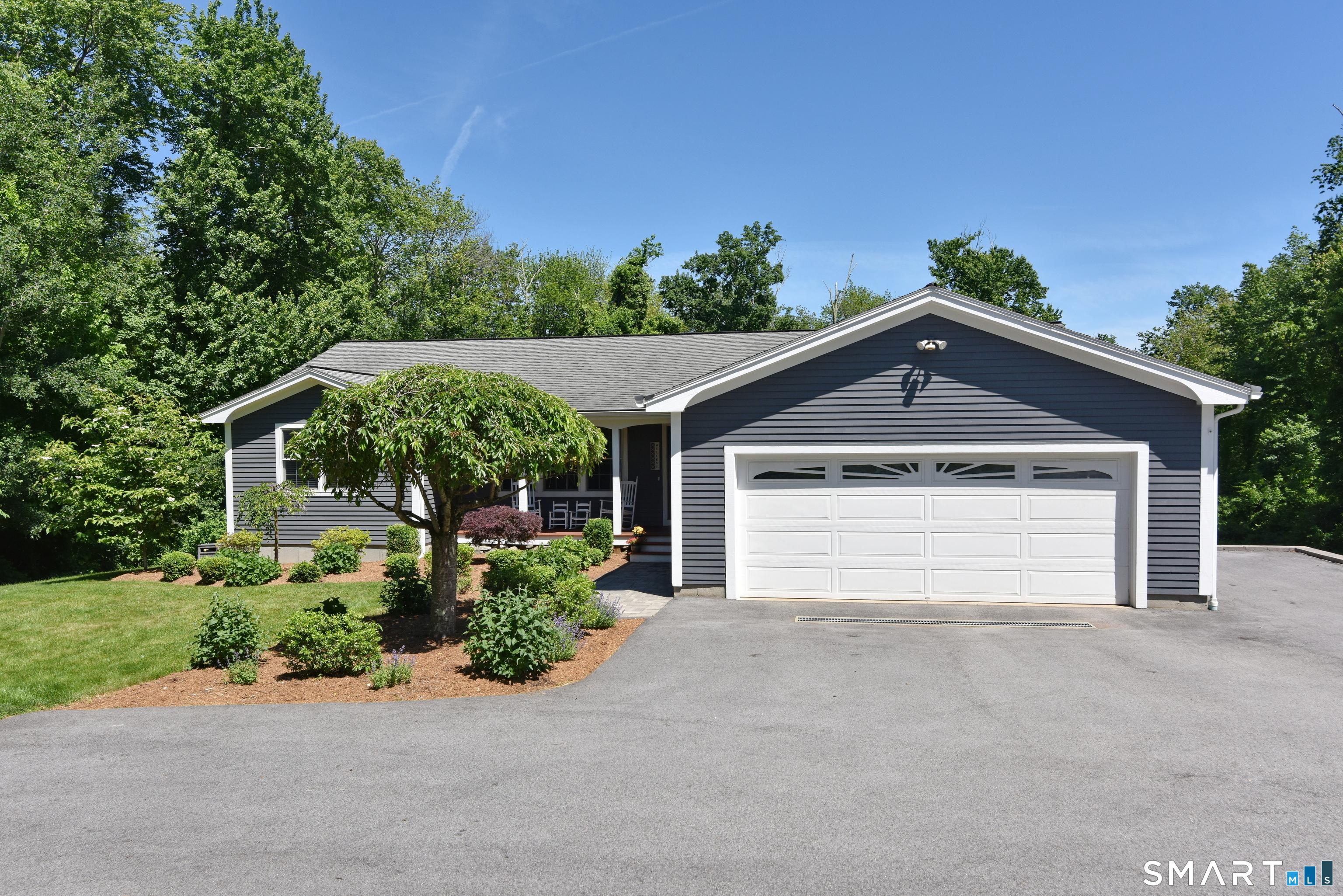 Image 1Front of House: Newly paved driveway, new laundry room, stamped concrete walkways, and landscaping.