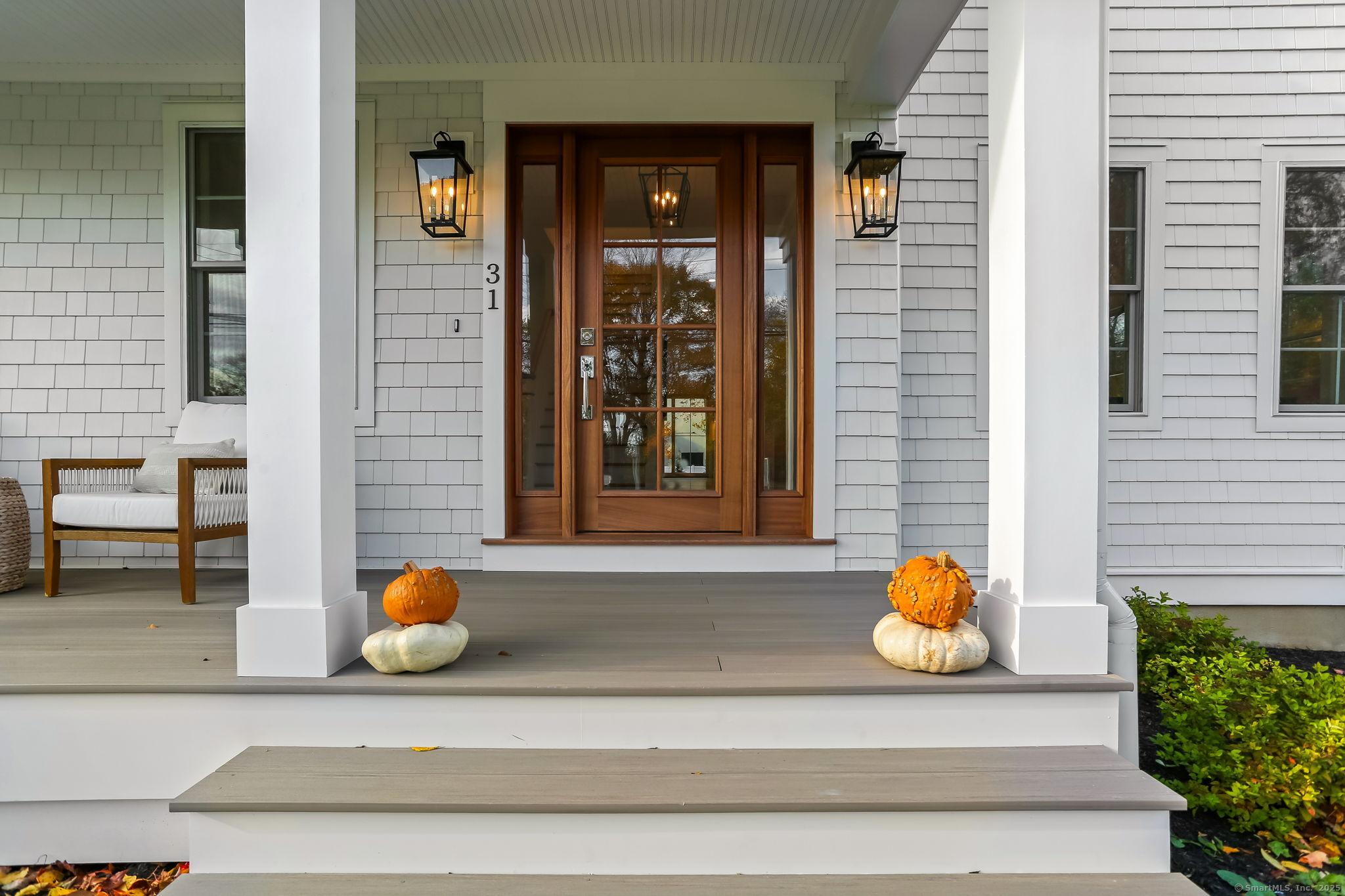 Image 4Front Door: Beautiful mahogany entryway door with side lights welcomes you right in