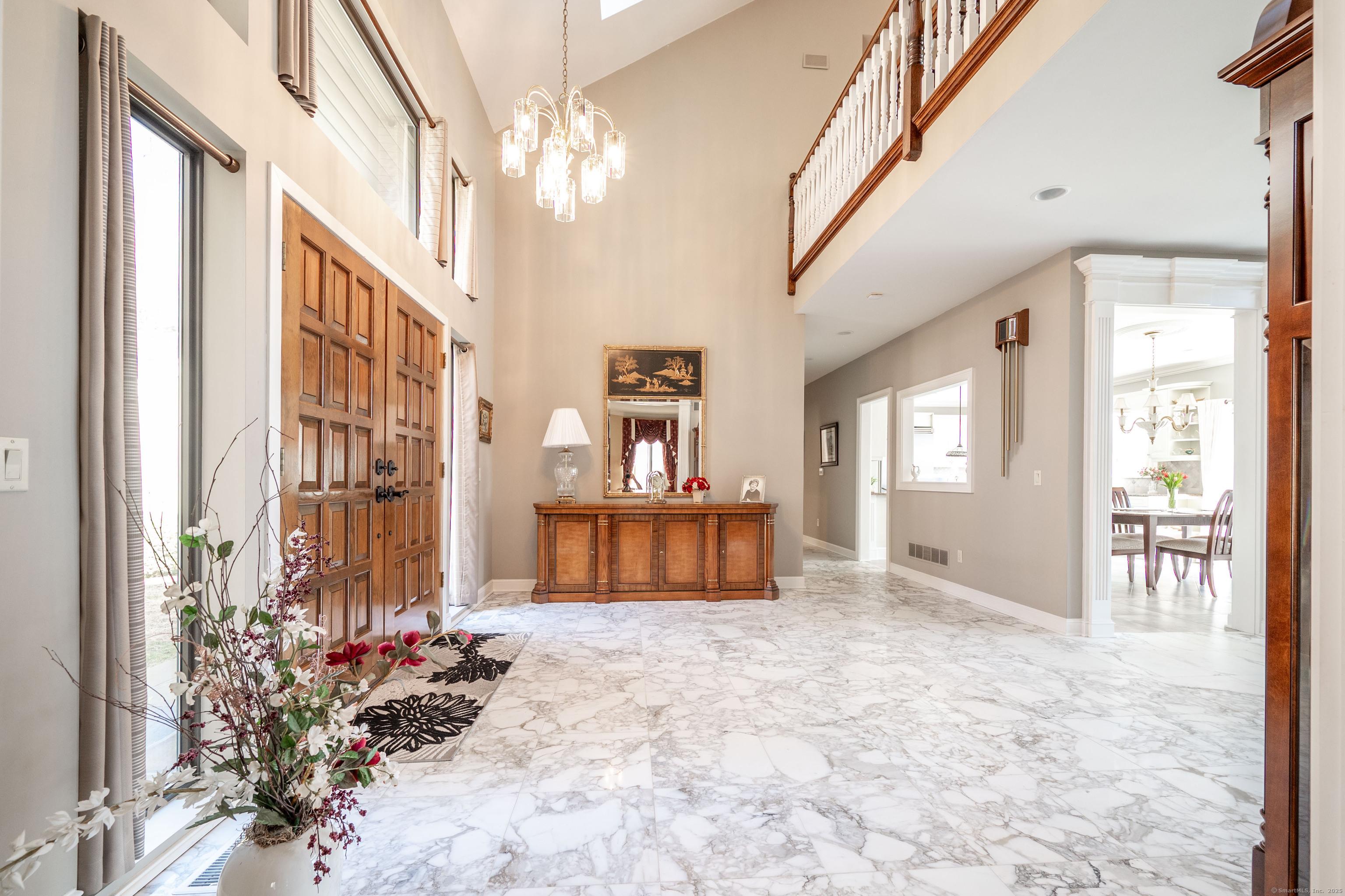 Image 4Entrance Foyer: Carrera Marble two story entrance foyer with skylights