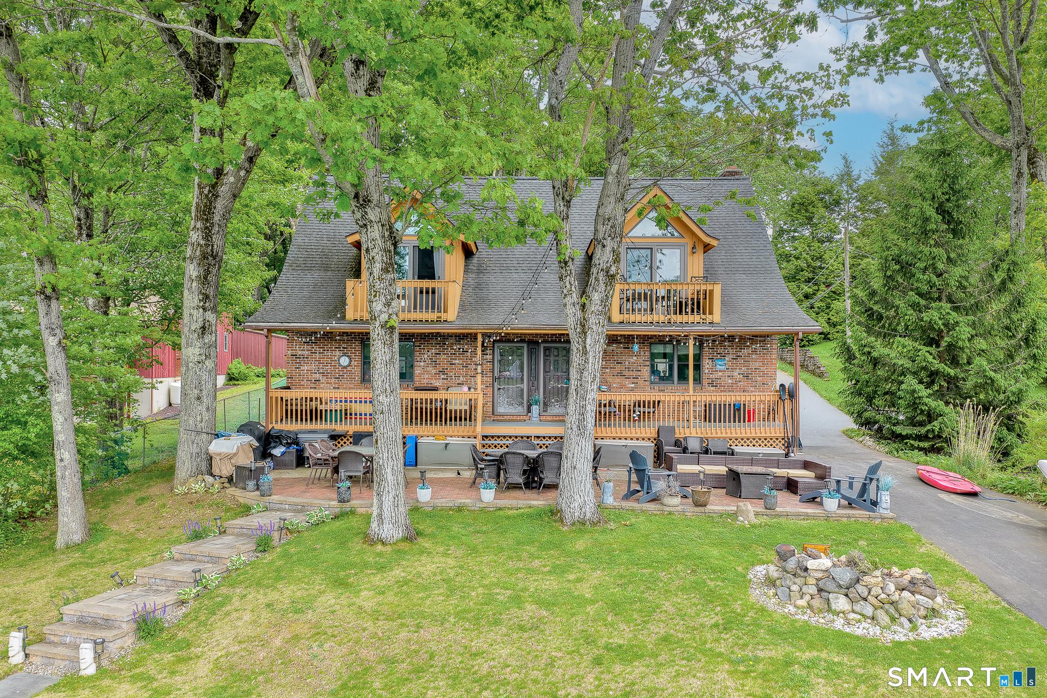 Image 1: Lake-side exterior view - deck, patio, & steps to the water
