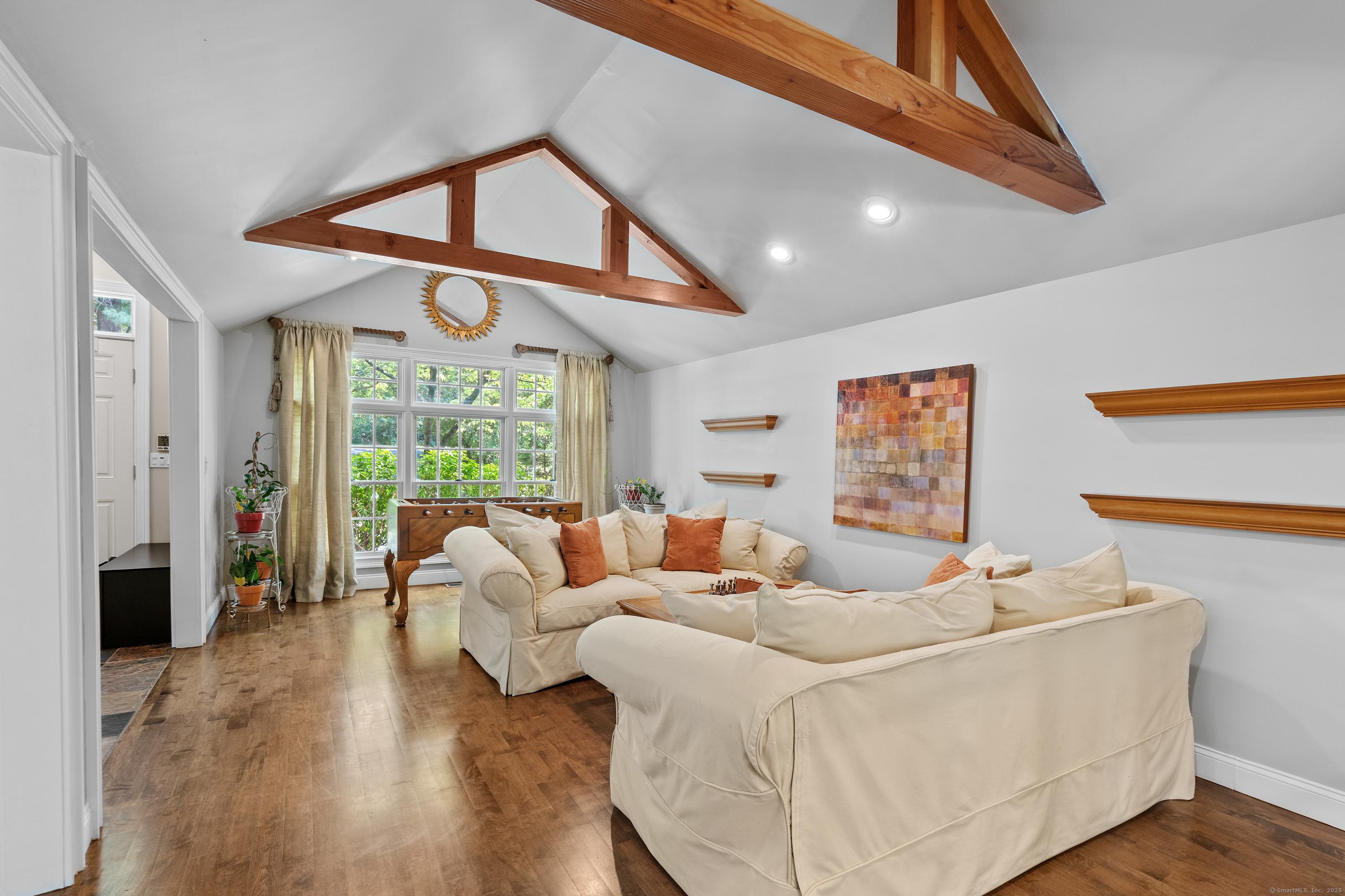 Image 4: The large and sunny living room with beautiful details and hardwood floors