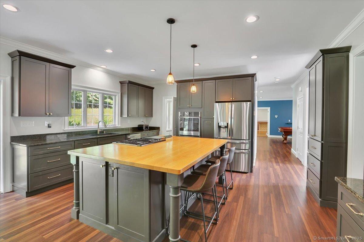 Image 4Kitchen: The kitchen was completely remodeled in 2023. New cabinets & countertops, island, appliances, flooring, lighting and plumbing.