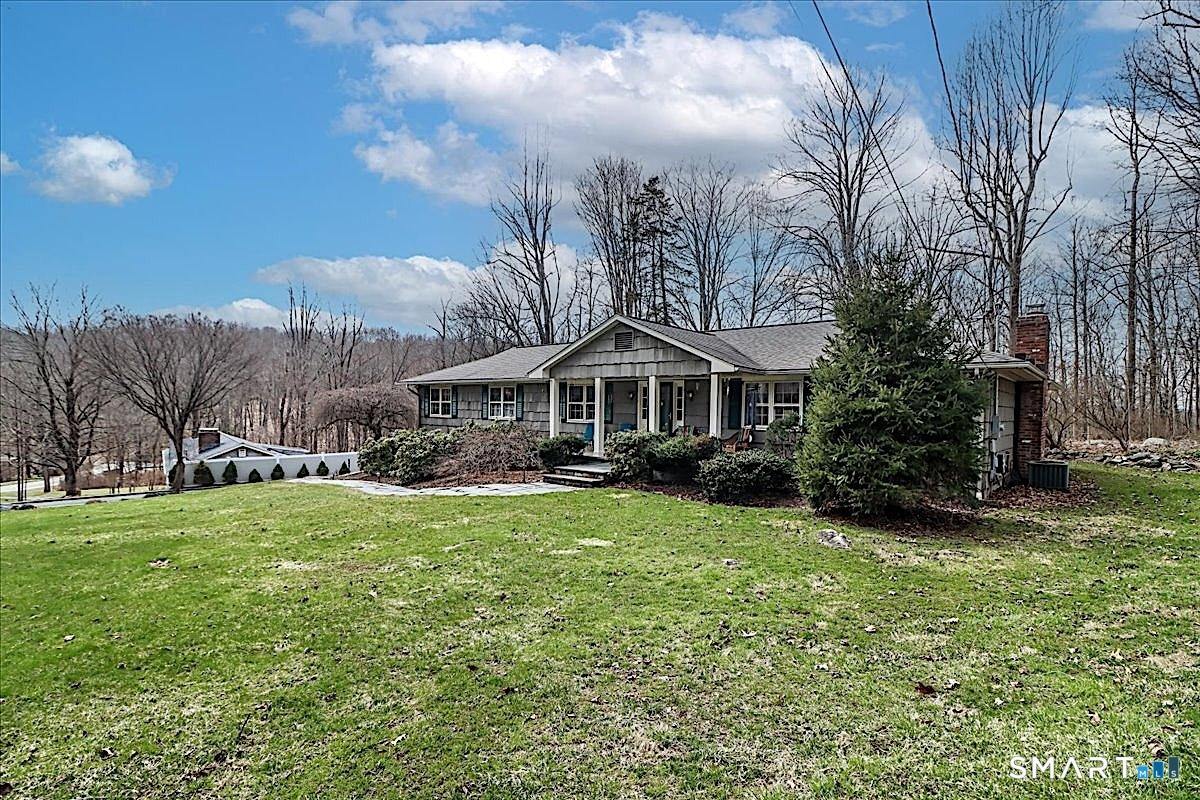 Image 2: Front Yard Surrounded by Mature Trees and Peaceful Natural Views