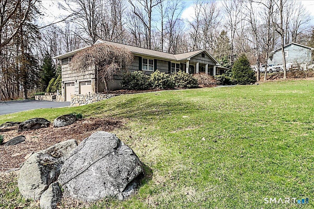 Image 4: A Gentle Slope to the Front Yard with a Bluestone Walkway Leading to the Front Door