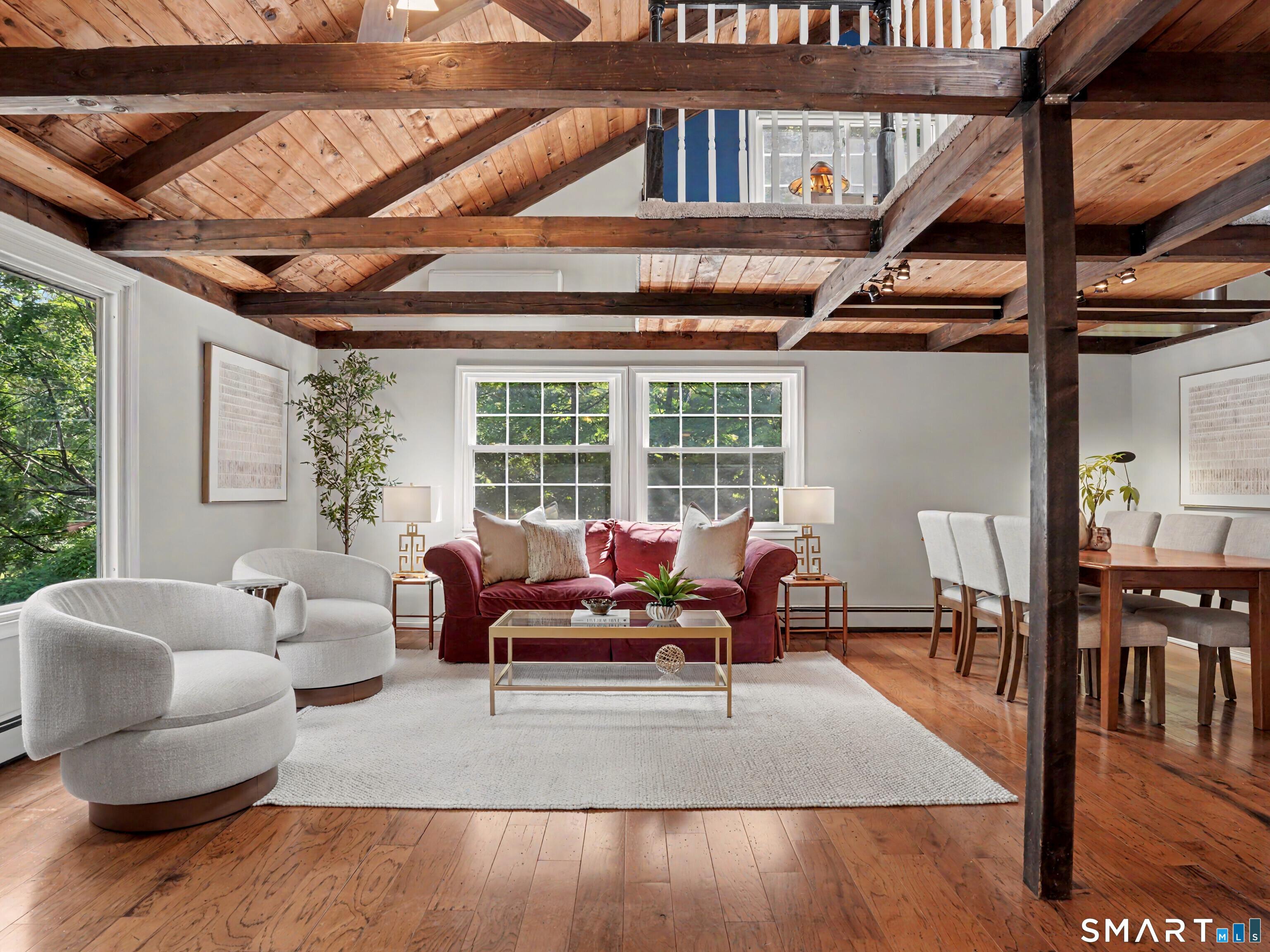 Image 2: The main level is designed around an open-concept flow with soaring cathedral ceilings.