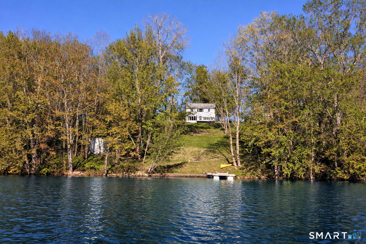 Image 3Waterfront: Idyllic lakefront setting with panoramic water views and unforgettable sunsets from this beautiful Quasset Lake home.