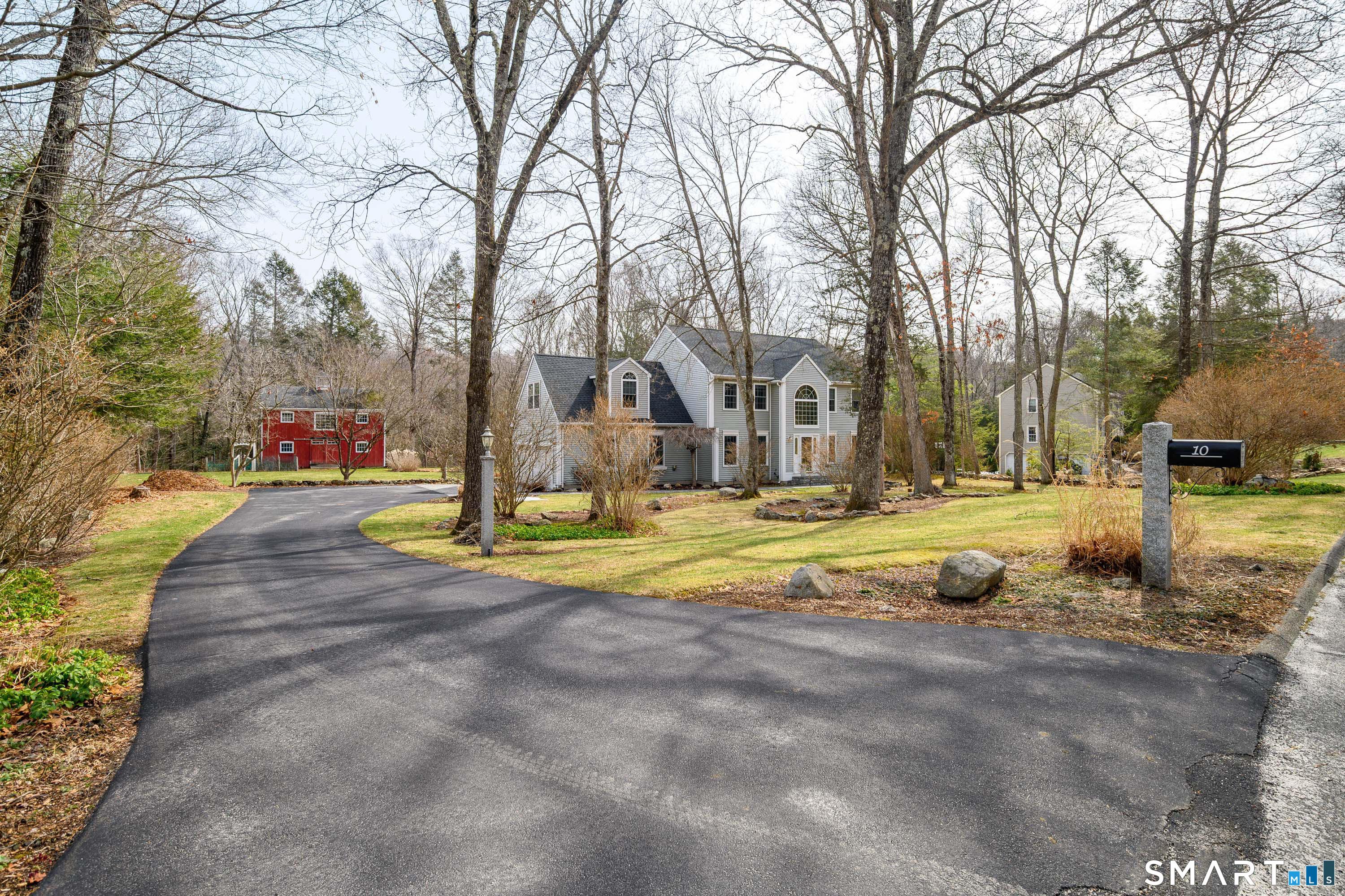 Image 4Front of Structure: Picture perfect! A sweeping level a lot. Don't miss the stone pillar mailbox, and the stone pillar lantern.