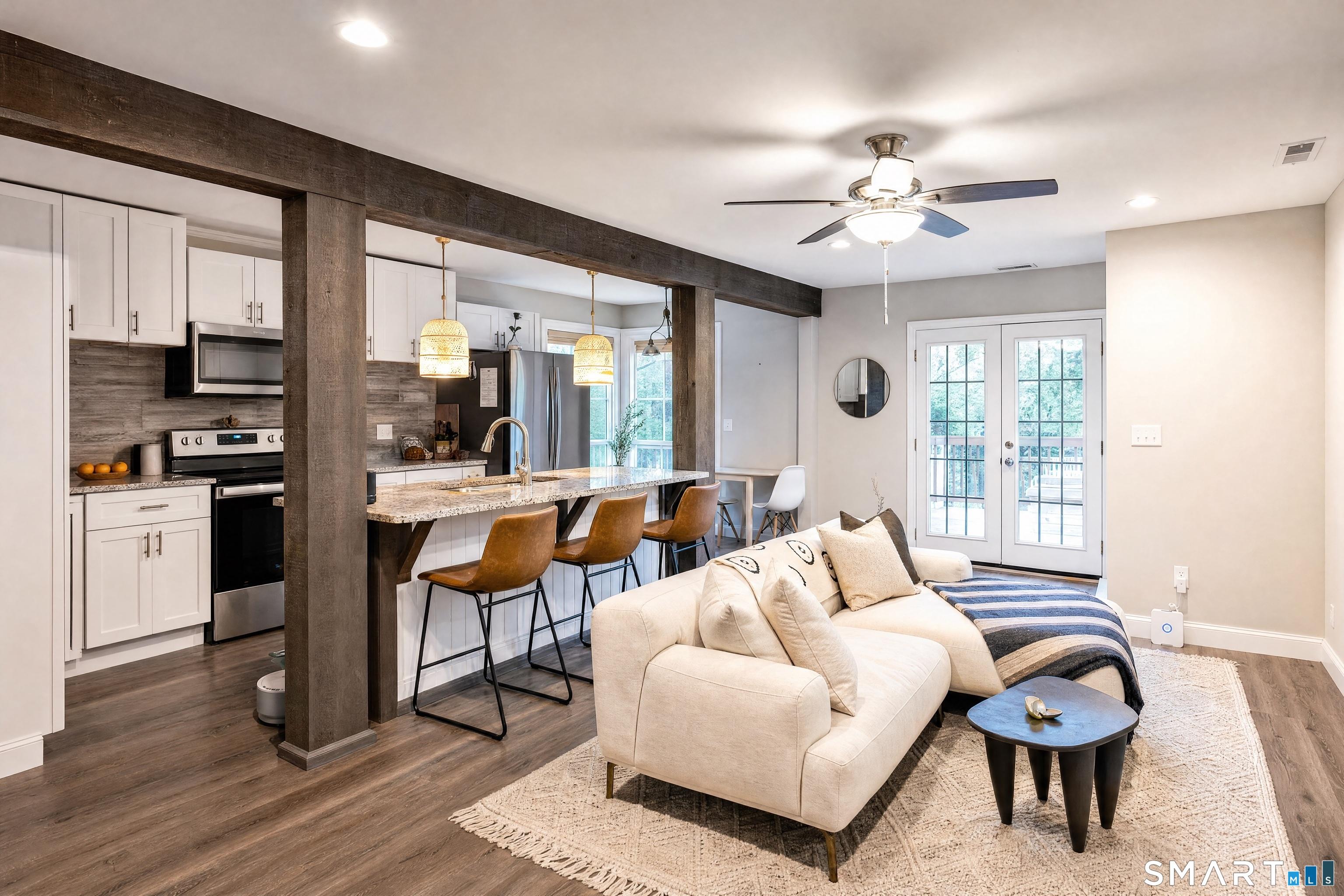Image 4: Kitchen Open to Living Room and Decks