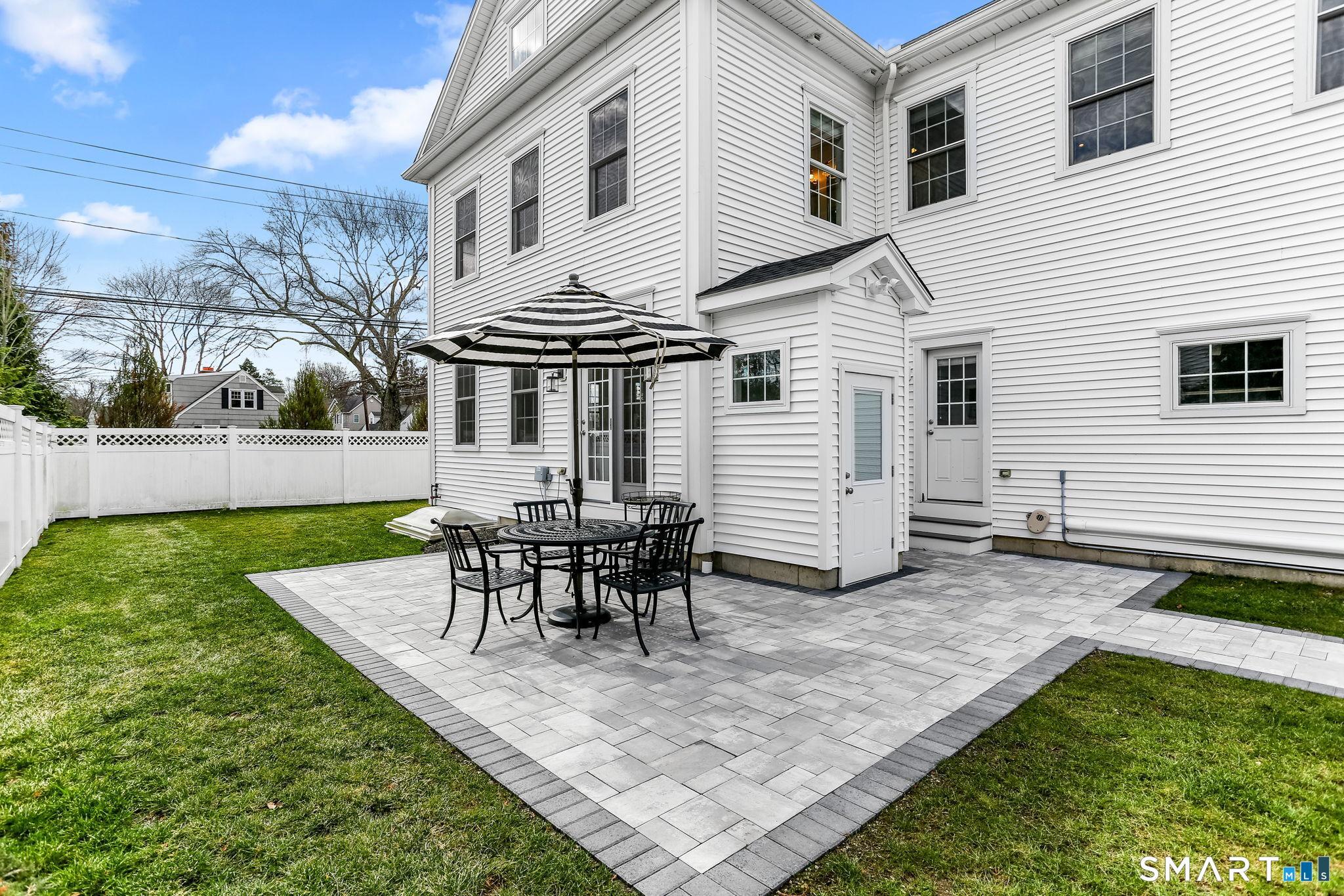 Image 3: Private backyard with new stone patio.