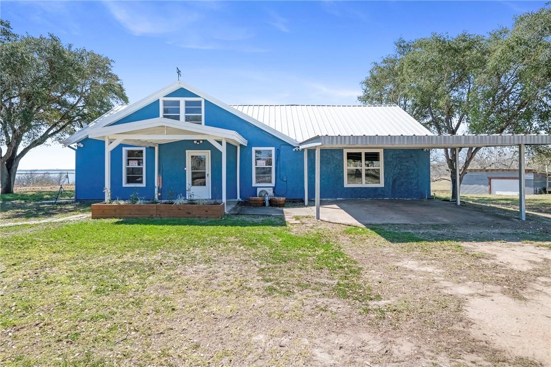 Image 1: Front View of Main House With Carport