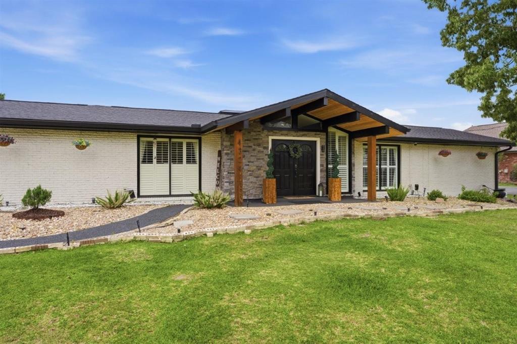 Image 2: Close up of Front Exterior.  Landscaped, manicured