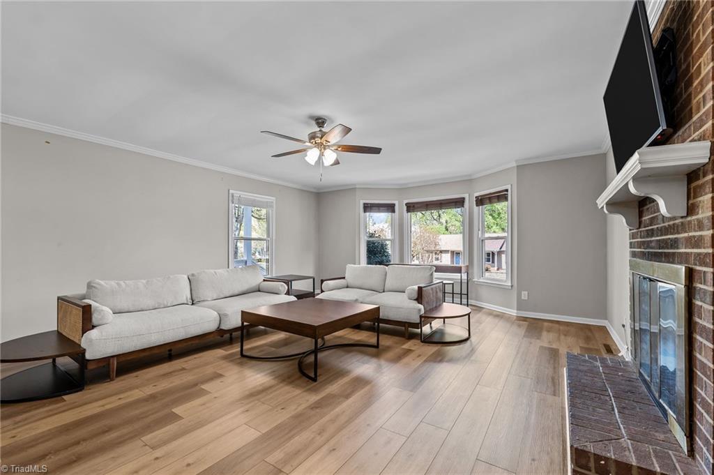 Image 4: Spacious living room centered around cozy fireplace