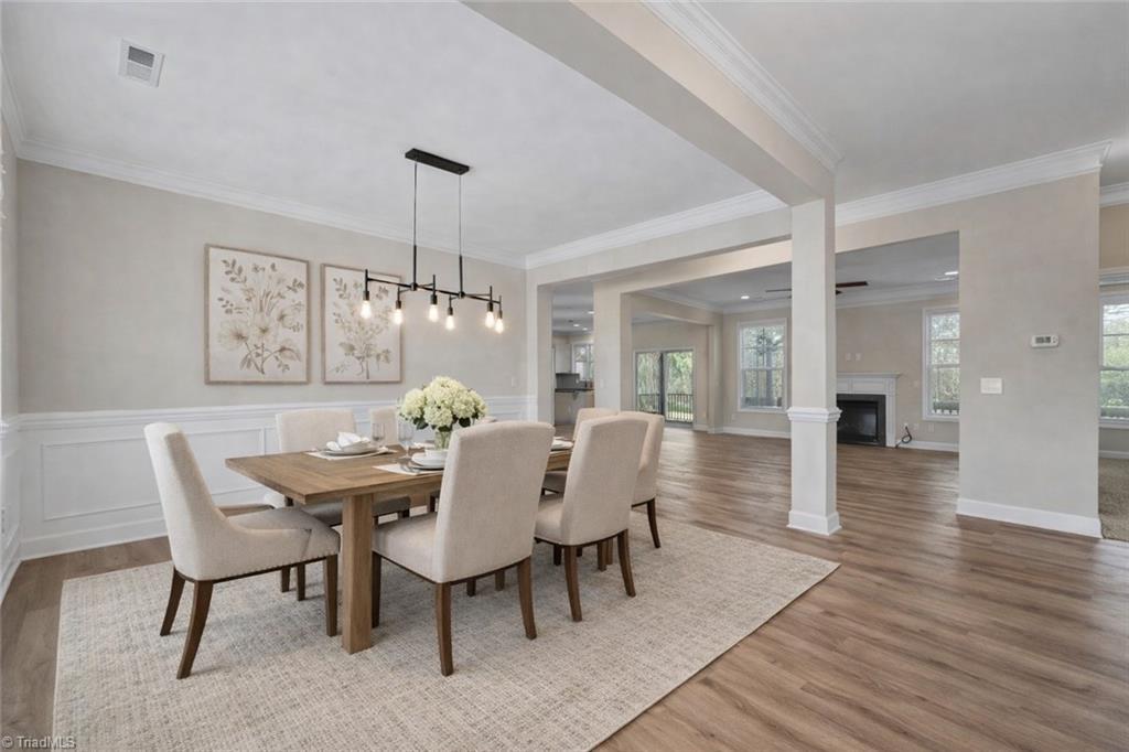 Image 2: Coming through the front door into the entry hall and dining room. (Virtually Staged)