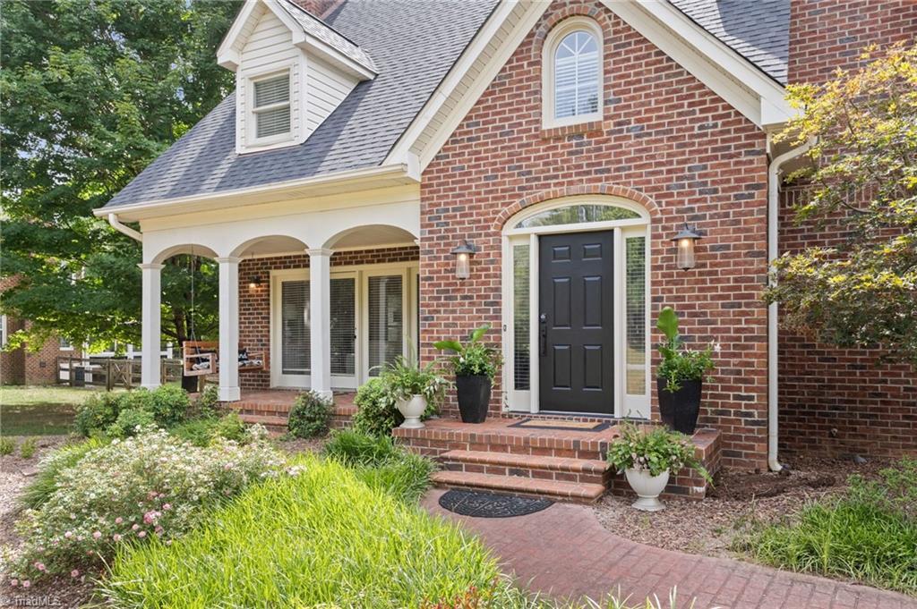 Image 3: front porch with swing on the left side of house