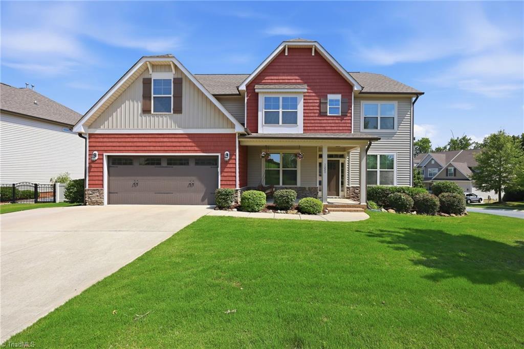 Image 1: Beautiful curb appeal with covered front porch and welcoming entry.