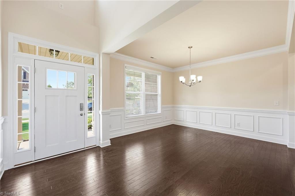 Image 4: Welcoming foyer opening to the formal dining room and main living areas.