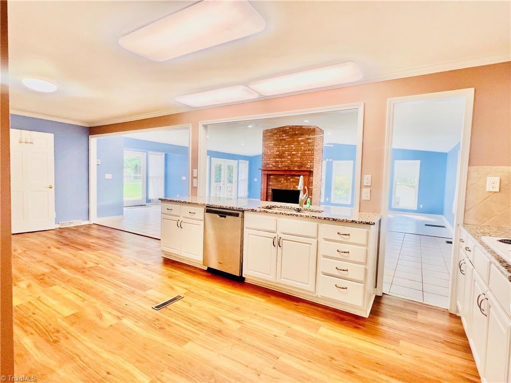 Image 1: From foyer doorway across kitchen, dining & den