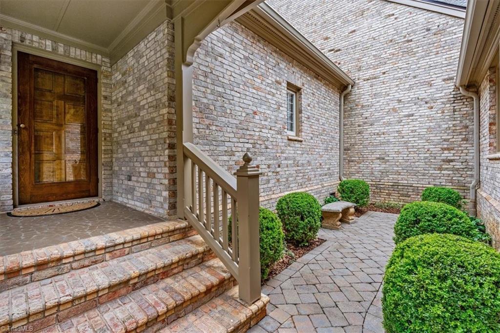 Image 2: Private garden area at entrance welcomes you home.