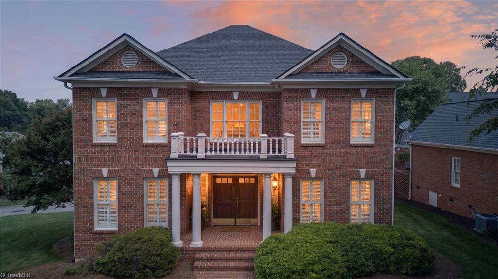 Image 1: Front of the home at sunset