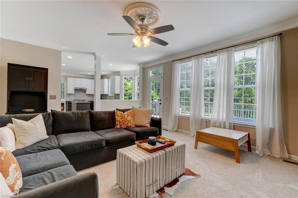 Image 3: Den area opens to the spacious kitchen and breakfast room. Door opens to the huge deck.