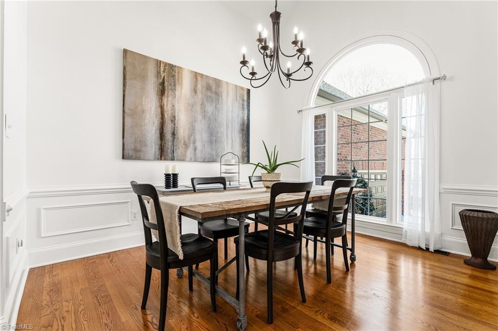 Image 3: Dining room features vaulted ceiling, large windows, wood floors and custom wood moldings.