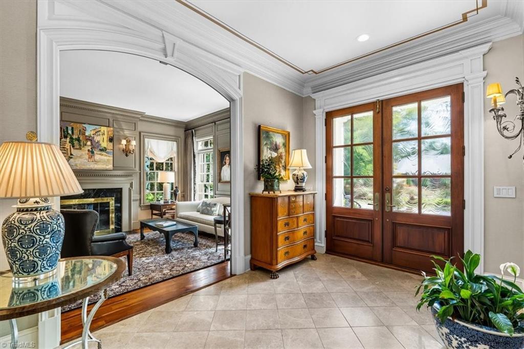 Image 3: foyer with double  Harville mahogany doors with seeded glass panes