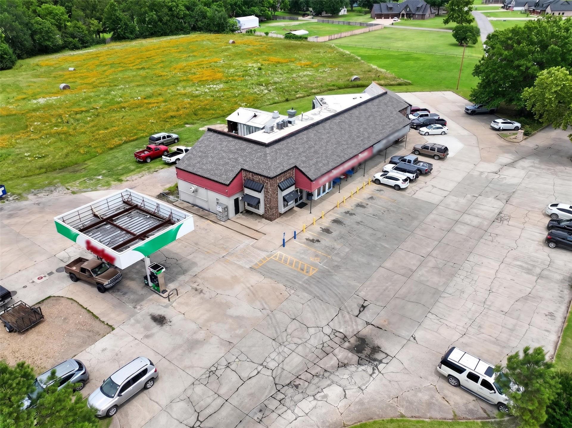 Image 2: Commercial property featuring a red and grey facad