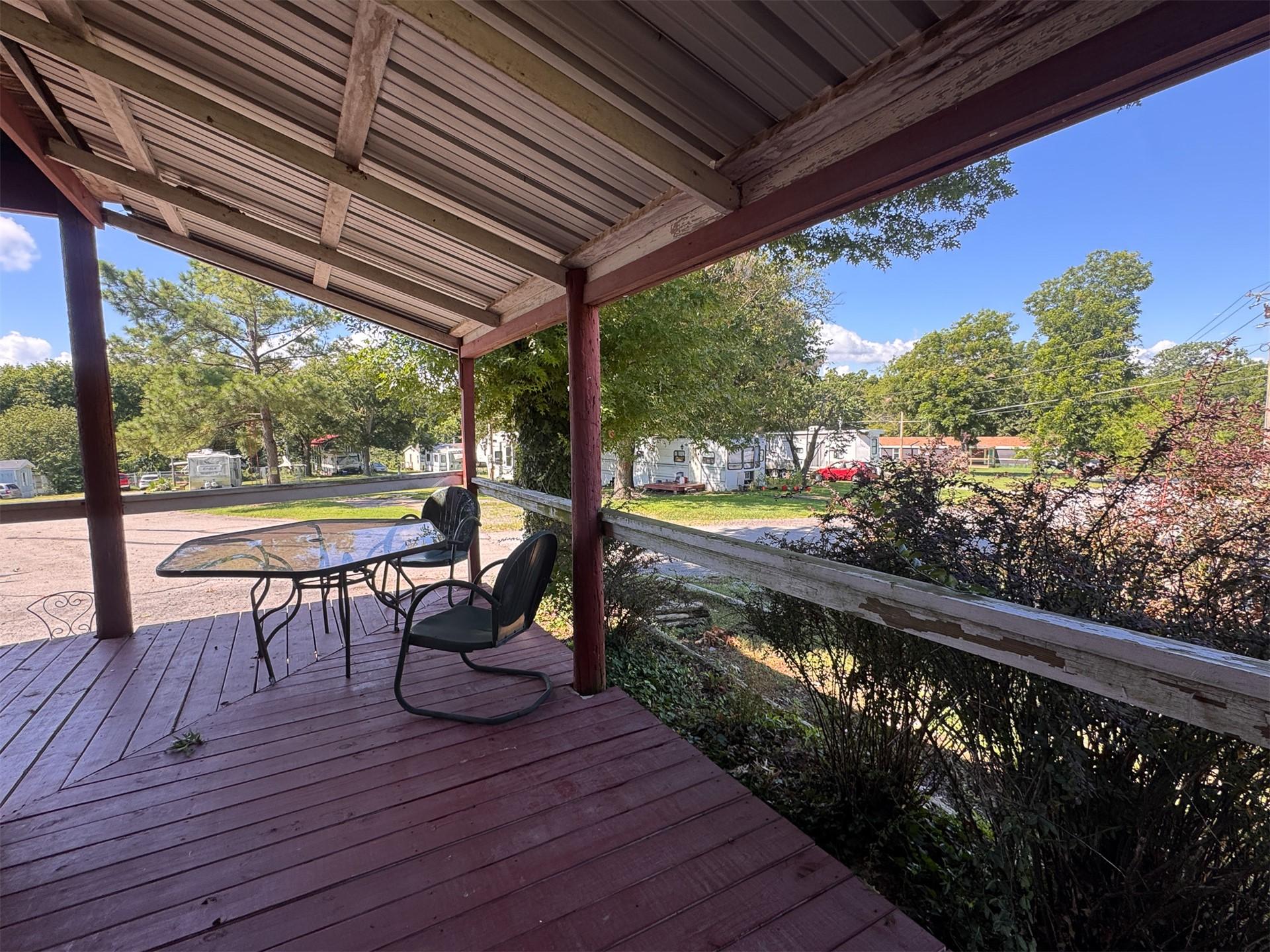 Image 4: Covered wood porch featuring a metal roof, wood su
