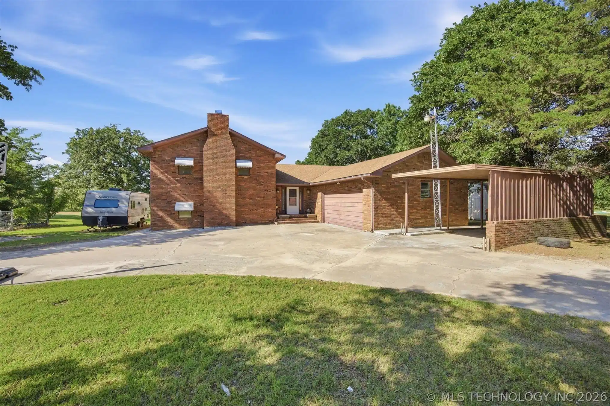 Image 1: Brick exterior residence featuring a prominent chi