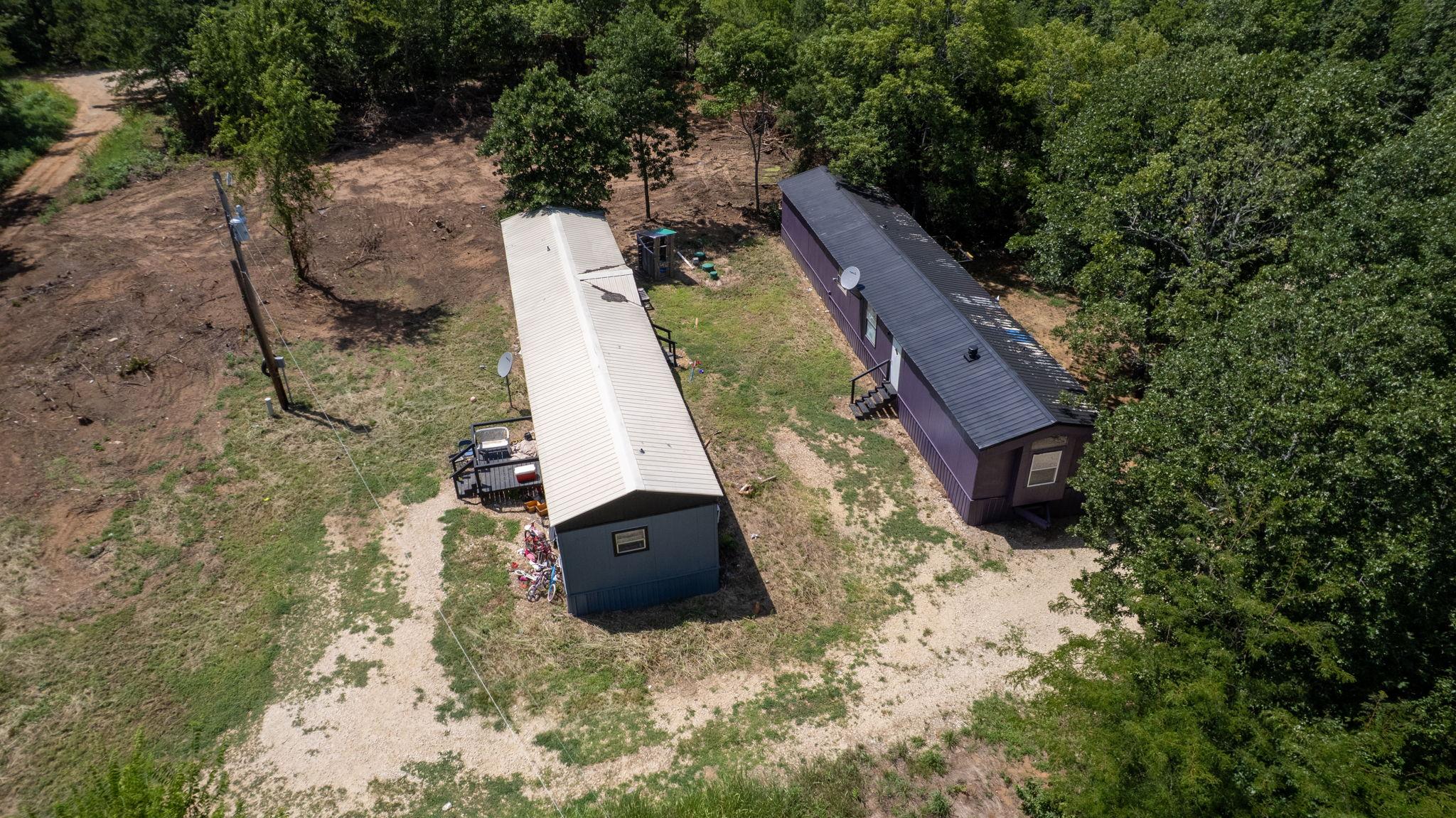 Image 2: Two residential structures situated on a partially