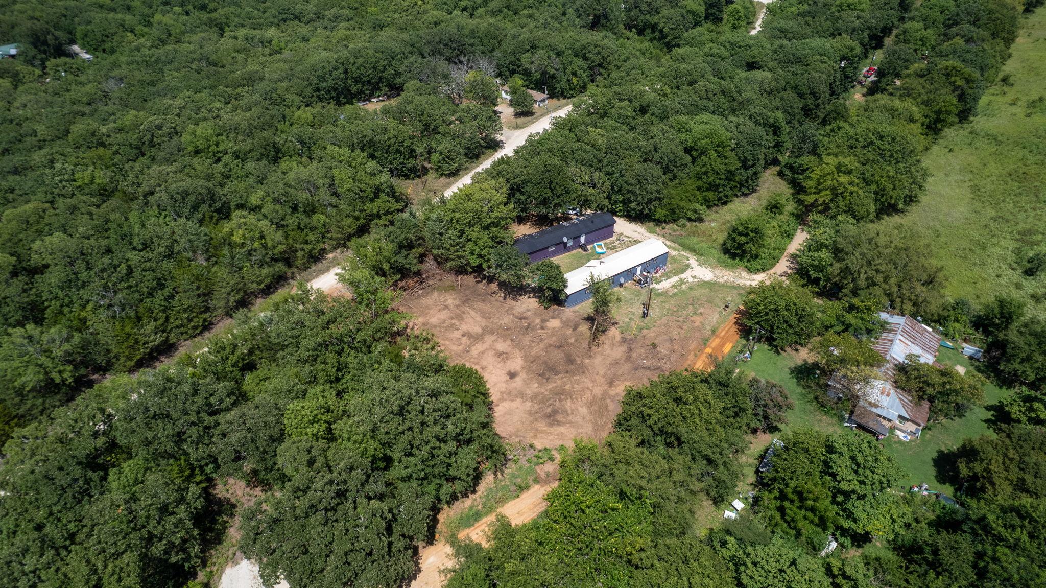 Image 4: Aerial overview showcasing a property surrounded b